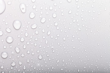 Drops of water on a color background. Selective focus. Gray