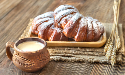Two buns with cup of coffee