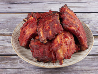 Homemade oven baked spareribs on rustic wooden background   