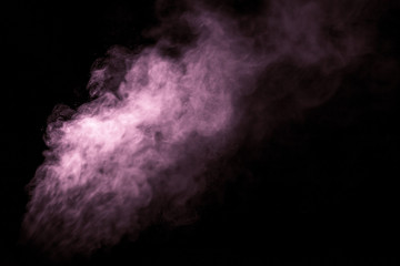 Jet of smoke on black background. Selective focus. Toned