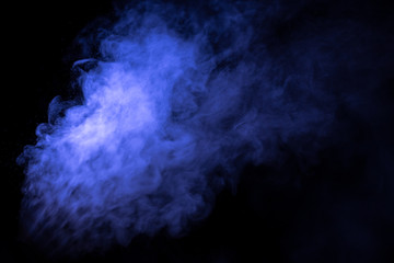 Jet of smoke on black background. Selective focus. Toned