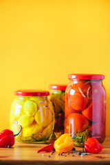 Сucumber, squash and tomatoes pickling and canning into glass jars. Ingredients for vegetables preserving. Healthy fermented food concept. Harvest storing