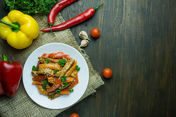 Bell pepper and meat salad. Asian food. Colorful hot salad. Dark background. Space for text.