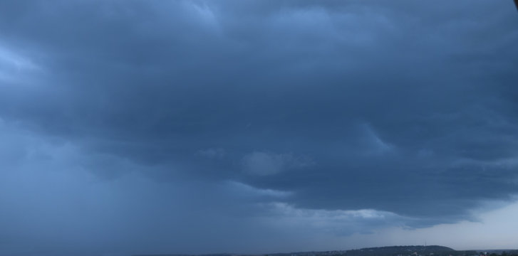 Panoramic photo of the sky. Late summer evening, dense cumulus clouds, pre-storm condition. 
