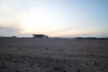 Wasteland at the construction site of a residential quarter on the outskirts of the city in the autumn evening