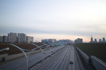 Expressway on the outskirts of the city on a fall evening