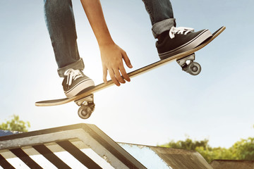 Fototapeta na wymiar Skateboarder skateboarding at skate park