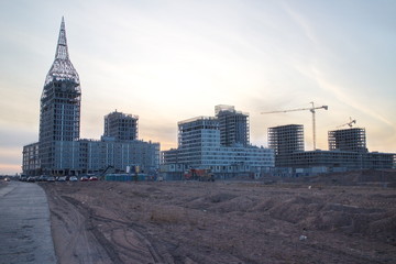 Fototapeta premium Construction of a residential quarter on the outskirts of the city on an autumn evening