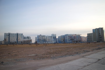 Wasteland at the construction site of a residential quarter on the outskirts of the city in the autumn evening