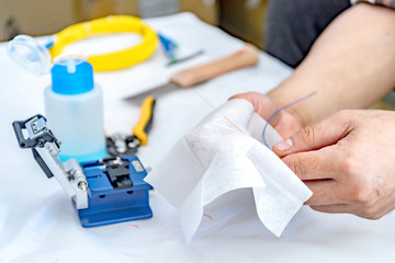 Expert technician Cleaning of fiber-optic cables With cleanser