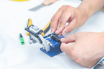 Fototapeta premium Expert technician Using a fiber-optic cable cutter With cutter For accuracy in work