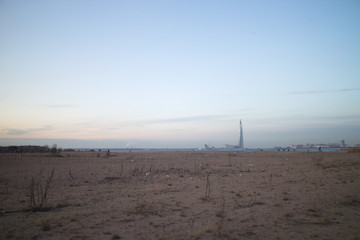 Wasteland at the construction site of a residential quarter on the outskirts of the city in the autumn evening