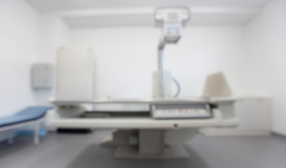 X-ray room with new machine and couch in blurred motion