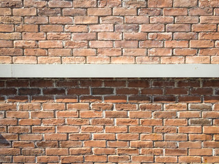 Orange brick wall With a steel band in the middle.