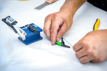 Expert technician Begin to arrange fiber optic cables by color to fit the head RJ 45