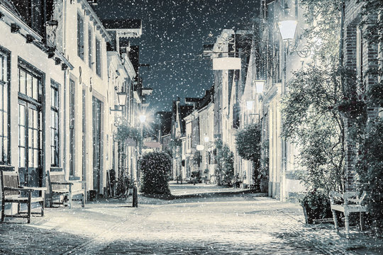 Shopping street with snowfall in the Dutch city center of Deventer