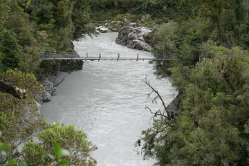 rope bridge above the grey Hokitika River