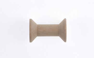 vintage wooden spool of thread isolated on white background