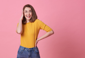 Excited beautiful woman happiness wearing casual yellow t-shirt isolated on pink background.