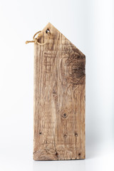 Fototapeta premium Handmade burned cutting board on a light background. Rough weathered wooden board