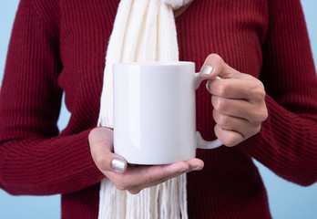 women hand holding white ceramic coffee cup. mockup for creative advertising text message or promotional content.