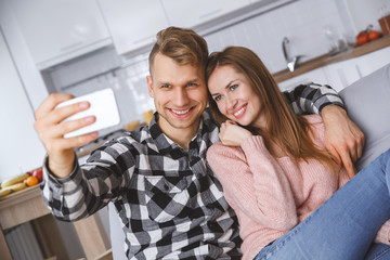 Fototapeta na wymiar Young couple together at home love concept taking selfie photos