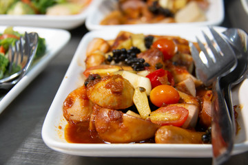  mixed sausage with tomato sauce in plate