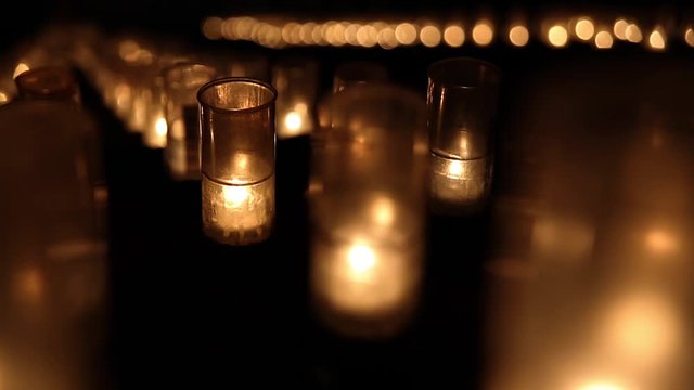 Candles burn on the steps of a temple, Japan