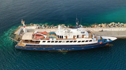Aerial drone photo of yacht docked in old port of Mykonos island at sunset, Cyclades, Greece