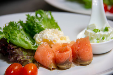  smoke salmon salad and sauce on plate