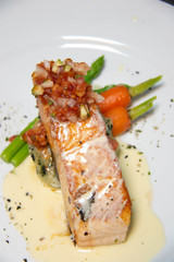  salmon steak with sauce on plate