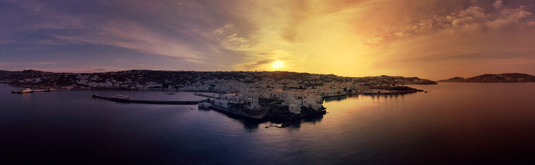 Aerial drone panoramic photo of picturesque old port in main village of Mykonos island at sunrise with beautiful colours, Cyclades, Greece - obrazy, fototapety, plakaty