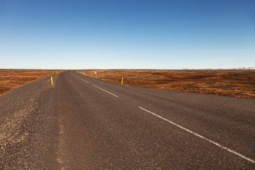 Obraz na płótnie Canvas Road on a calm deserted spring landscape of Iceland