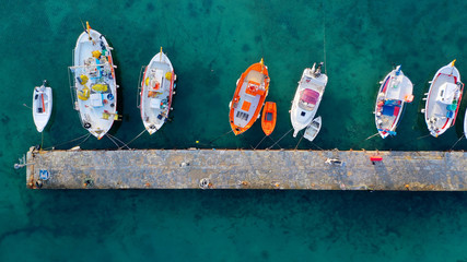 Aerial drone photo of traditional wooden fishing boat in old port of Mykonos island,  Cyclades,...