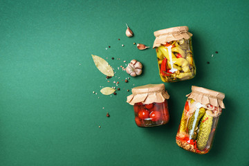 Сucumber, squash and tomatoes pickling and canning into glass jars. Ingredients for vegetables...