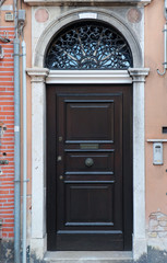 Old door with ruined facade