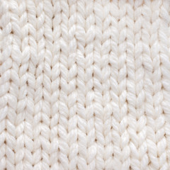 White knitted texture background. Warm winter clothes.