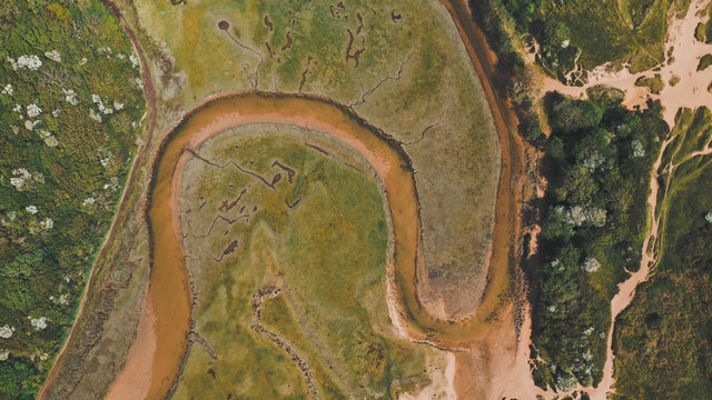Aerial view of beatiful river meander in wonderful green Three Cliffs Bay, Wales