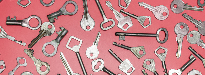 Keys set on pink background. Door lock keys and safes for proper