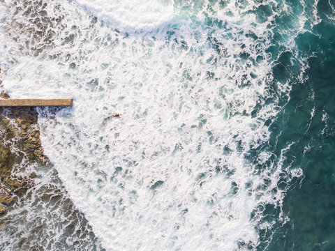 Aerial view of a man surfing at an agitated sea near Lo?inj coastline, Croatia.