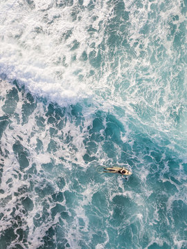 Aerial view of a man surfing at an agitated sea near Lo?inj coastline, Croatia.