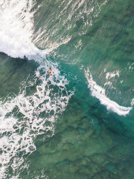 Aerial view of a man surfing at an agitated sea near Lo?inj coastline, Croatia.