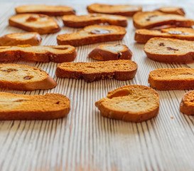 Wheat rusks on a wooden background. Background from rusks. Photographed close-up.
