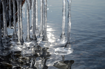 The first lies on pebbles on the shore at the beginning of winter.