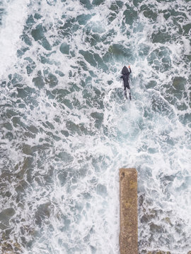 Aerial view of a man surfing at an agitated sea near Lo?inj coastline, Croatia.