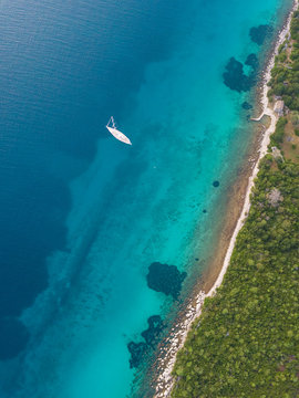 Aerial view of single speed boat floating over transparent water, Croatia.