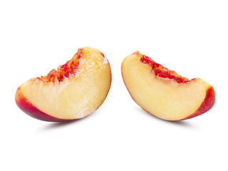 Two unpitted, smooth-skinned nectarine fruit slices isolated on white background with copy space for text or images. Close-up shot.