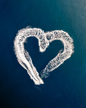 Aerial view above of speed boats drawing heart shape at Adriatic sea, Croatia.