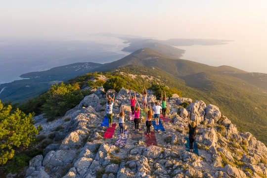 Aerial view of group practicing yoga at top of mountain, Veli Lo?inj, Croatia.