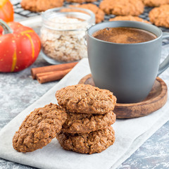 Spicy pumpkin and oatmeal cookies with  cup of coffee, square format